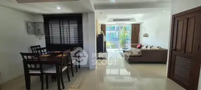 Spacious open-plan living and dining area with modern furnishings and natural light.