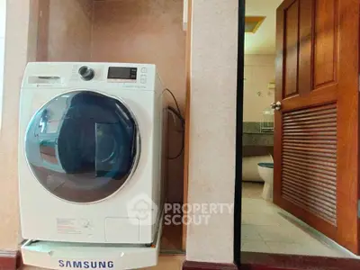 Modern bathroom with Samsung washing machine and wooden door