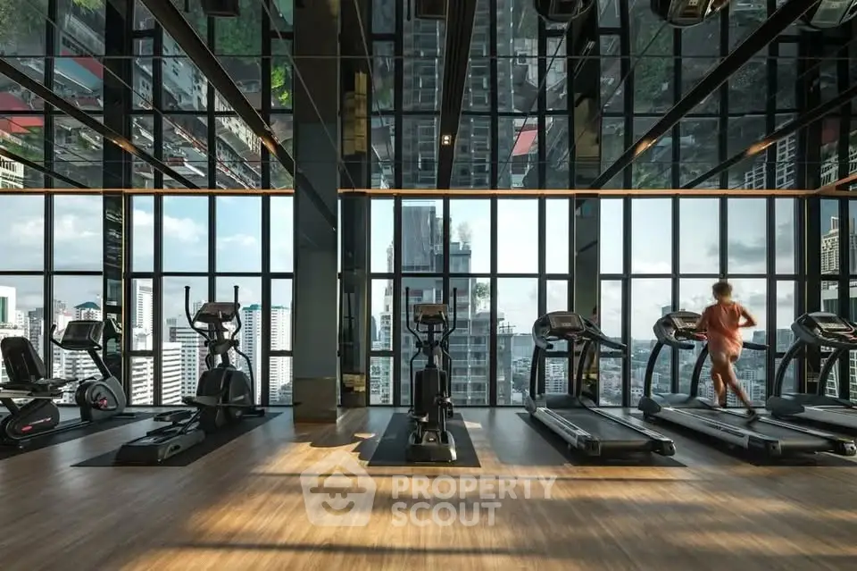 Luxurious high-rise gym with panoramic city views and modern fitness equipment.
