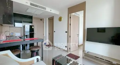 Modern living room with sleek furniture and wall-mounted TV in a stylish apartment.