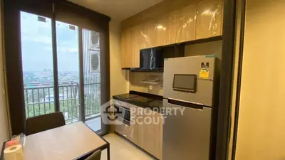 Modern kitchen with sleek cabinets and balcony view in urban apartment