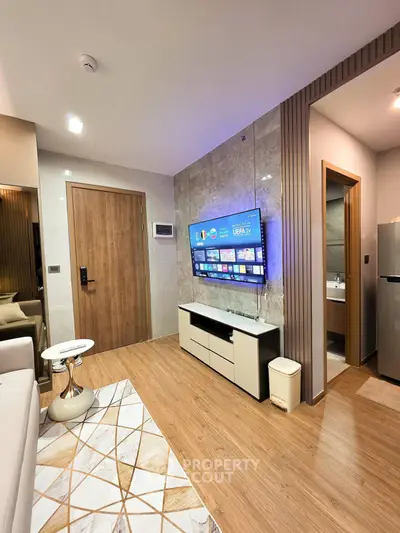 Modern living room with wall-mounted TV and stylish decor