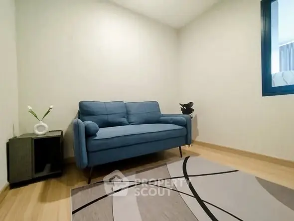 Cozy living room with modern blue sofa and stylish decor