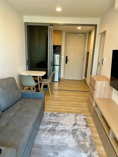 Modern living room with stylish furniture and open kitchen layout in a cozy apartment.