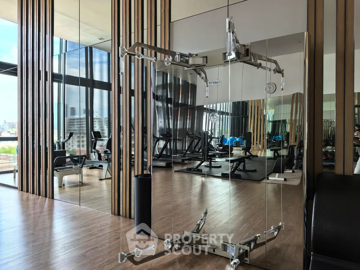 Luxurious modern gym with floor-to-ceiling windows and sleek exercise equipment.