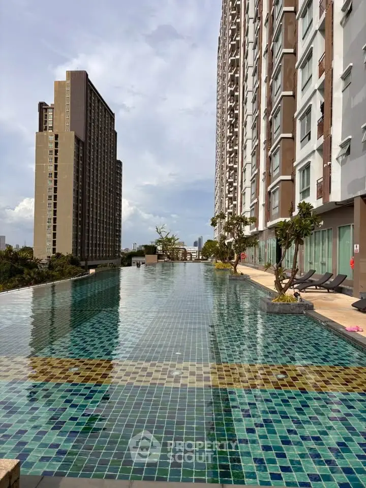Luxurious high-rise apartment with stunning rooftop infinity pool and city views.
