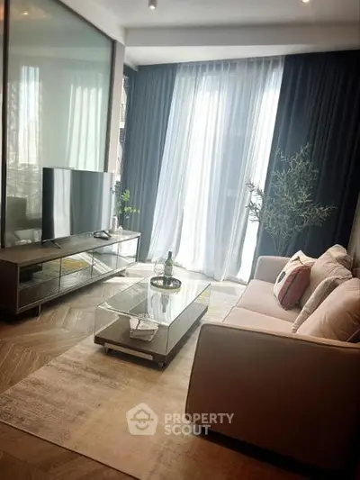 Elegant living room with modern decor, large TV, and floor-to-ceiling windows for natural light.