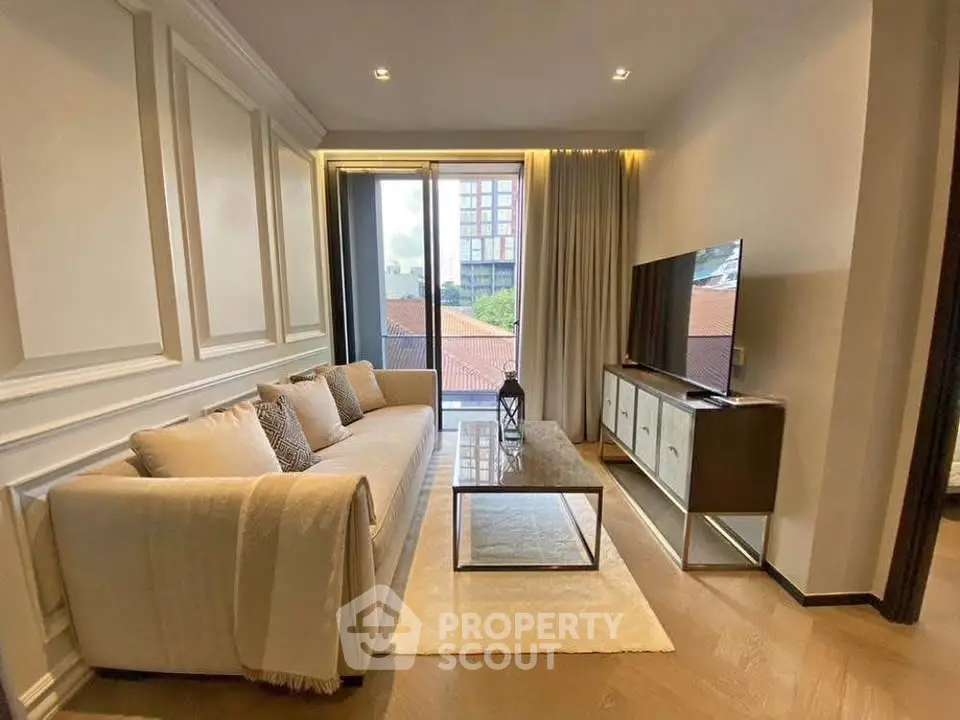 Elegant living room with modern decor, large sofa, and flat-screen TV, featuring floor-to-ceiling windows with city view.