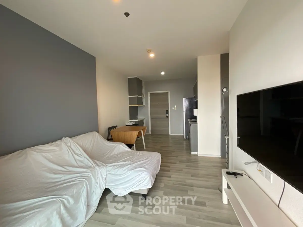 Modern living room with sleek flooring and minimalistic furniture in a stylish apartment.