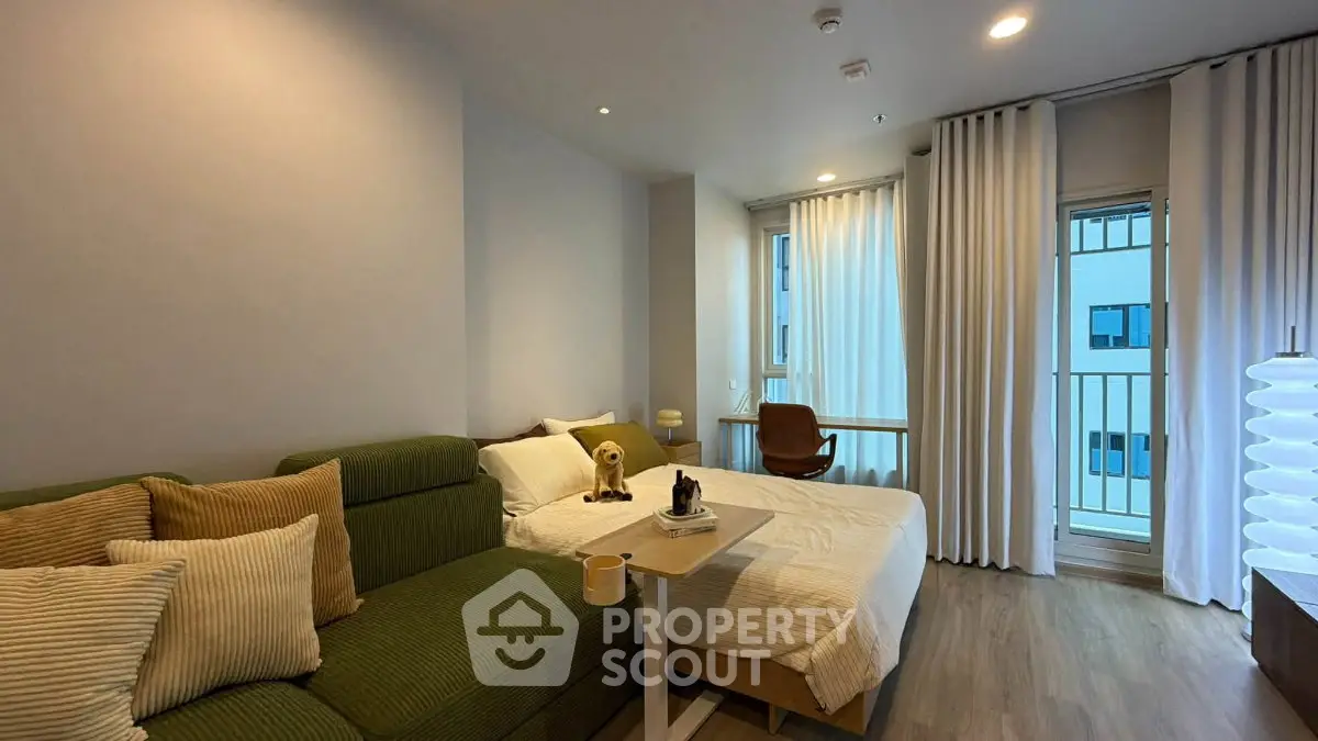 Modern studio apartment with cozy living area and natural light