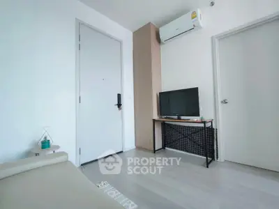 Modern minimalist living room with air conditioning and TV setup.