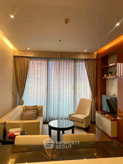 Luxurious living room with elegant furniture and large windows offering natural light.