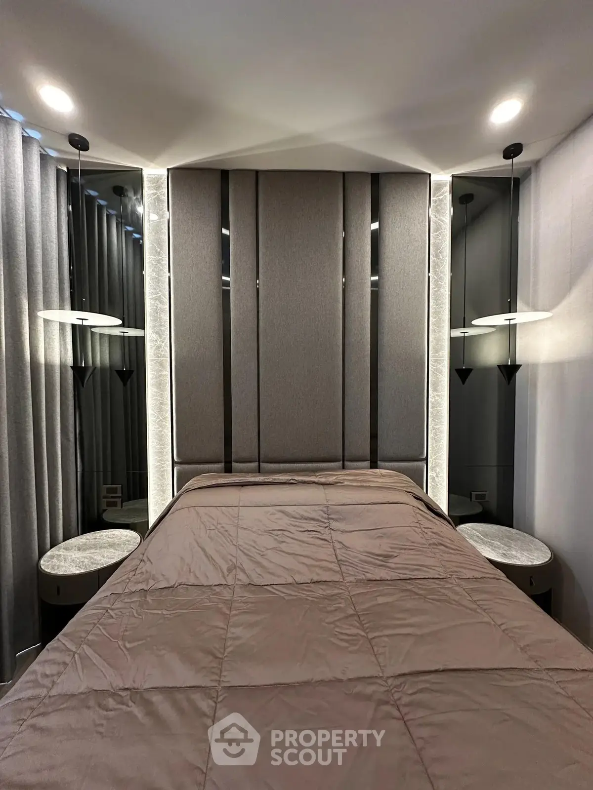 Luxurious bedroom with modern lighting and elegant decor, perfect for a cozy and stylish living experience.