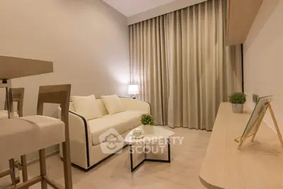 Modern living room with cozy sofa, elegant decor, and warm lighting for a welcoming ambiance.