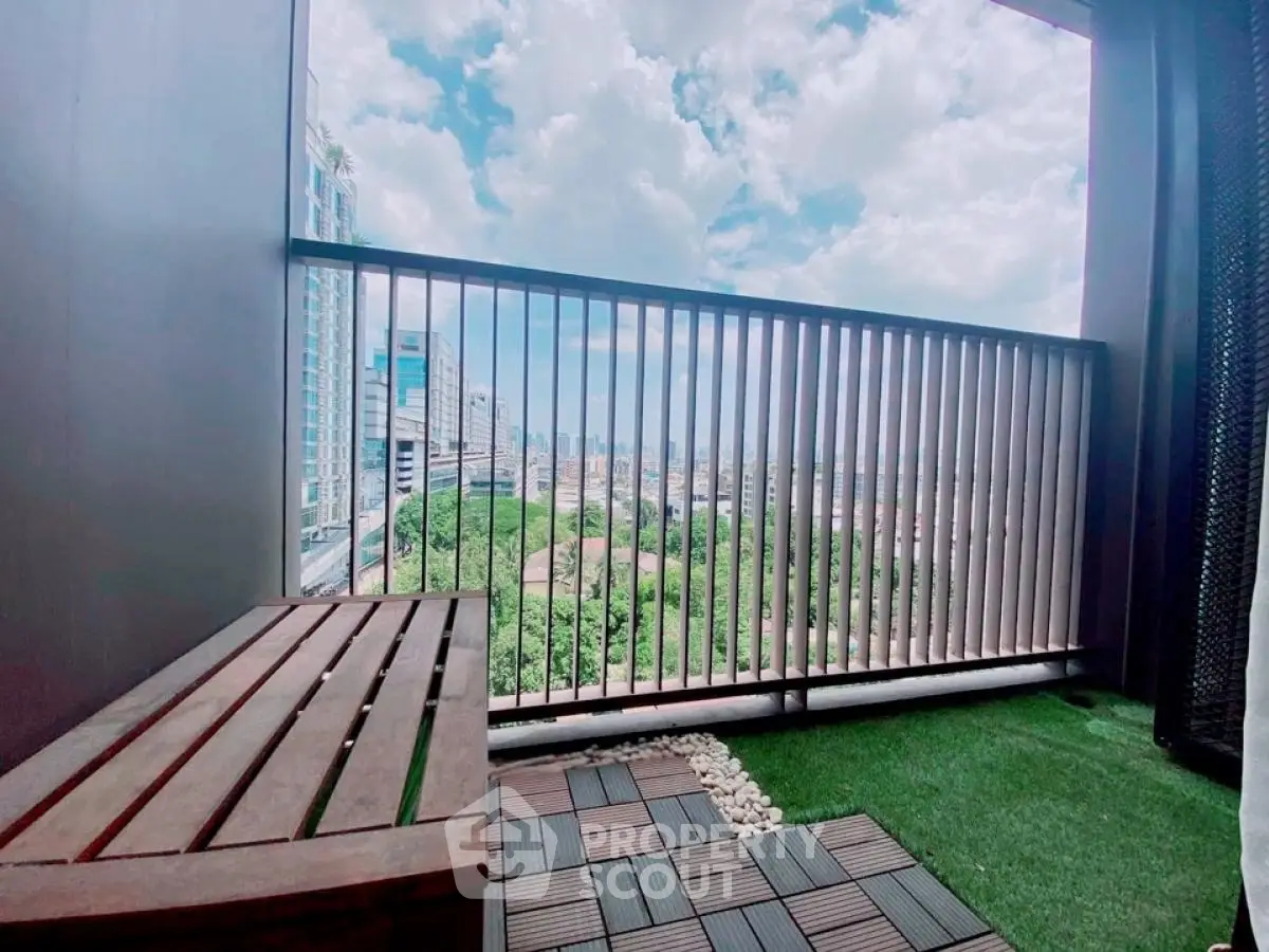 Charming balcony with stunning city view and cozy seating area.