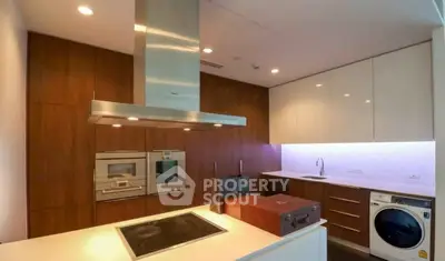 Modern kitchen with sleek appliances and wooden cabinetry