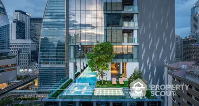 Stunning modern building with rooftop pool and lush greenery in urban setting.