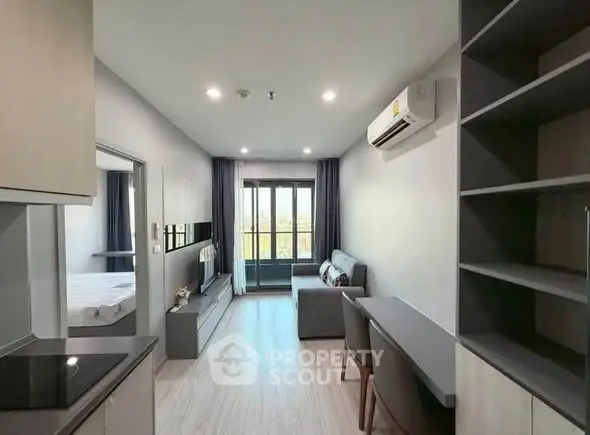 Modern living room with sleek design and balcony view in a stylish apartment.