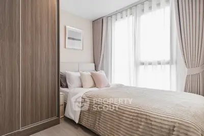 Modern bedroom with elegant decor and large window for natural light.