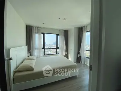 Spacious bedroom with panoramic city view and modern decor