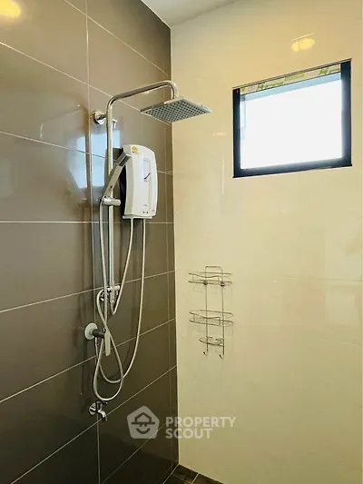 Modern bathroom with sleek shower and natural light window