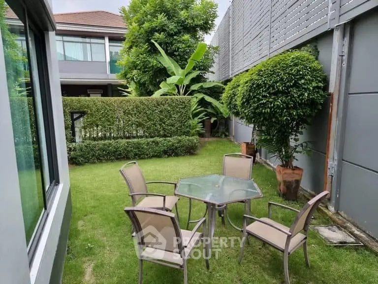 Charming garden with patio furniture in modern residential property