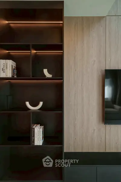 Modern living room with sleek built-in shelving and wall-mounted TV