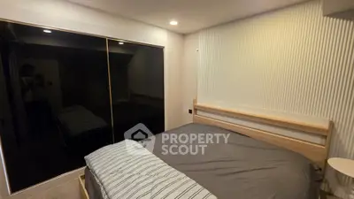 Modern bedroom with sleek design and mirrored wardrobe doors, perfect for urban living.