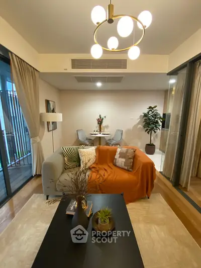Modern living room with stylish decor and cozy ambiance, featuring elegant lighting and a comfortable seating area.