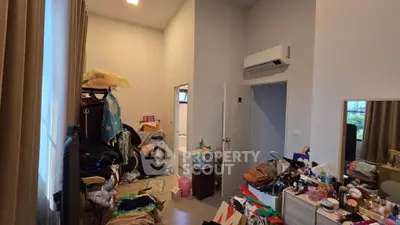 Spacious bedroom with modern air conditioning and ample storage space.