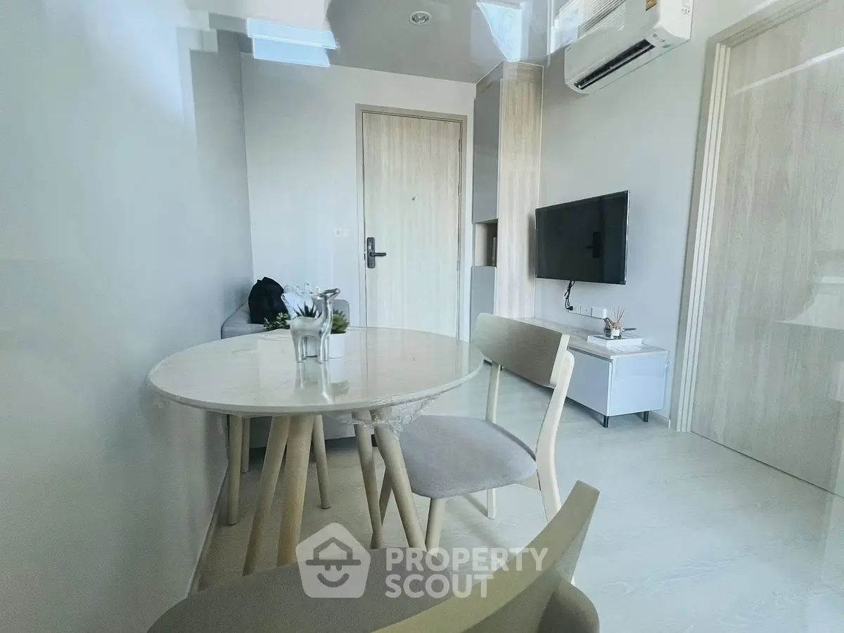 Modern minimalist living room with sleek furniture and wall-mounted TV
