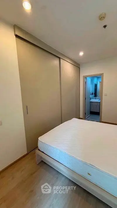 Spacious bedroom with sliding closet doors and ensuite bathroom