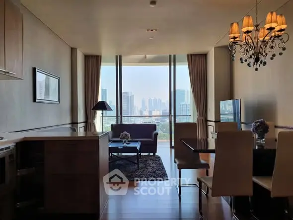 Luxurious living room with stunning city view, elegant chandelier, and modern furnishings in high-rise apartment.