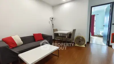 Cozy living room with modern furniture and open view to adjacent room