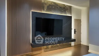 Modern living room with sleek TV wall design and ambient lighting