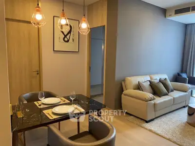 Modern living room with elegant dining area and stylish lighting