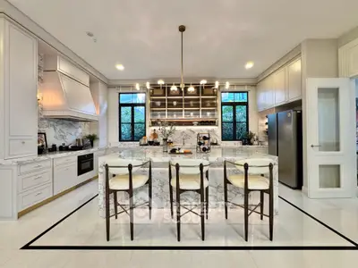 Luxurious modern kitchen with marble island and elegant lighting