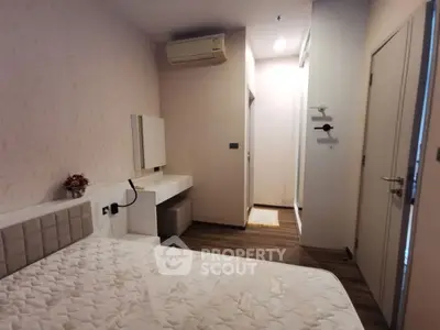 Cozy bedroom with modern decor and air conditioning in a stylish apartment.