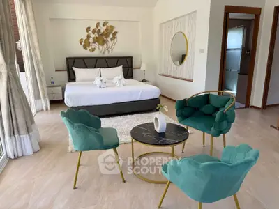 Luxurious bedroom with elegant decor and stylish furniture, featuring a cozy seating area and modern design.