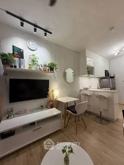 Modern open-plan living room and kitchen with stylish decor and cozy ambiance.