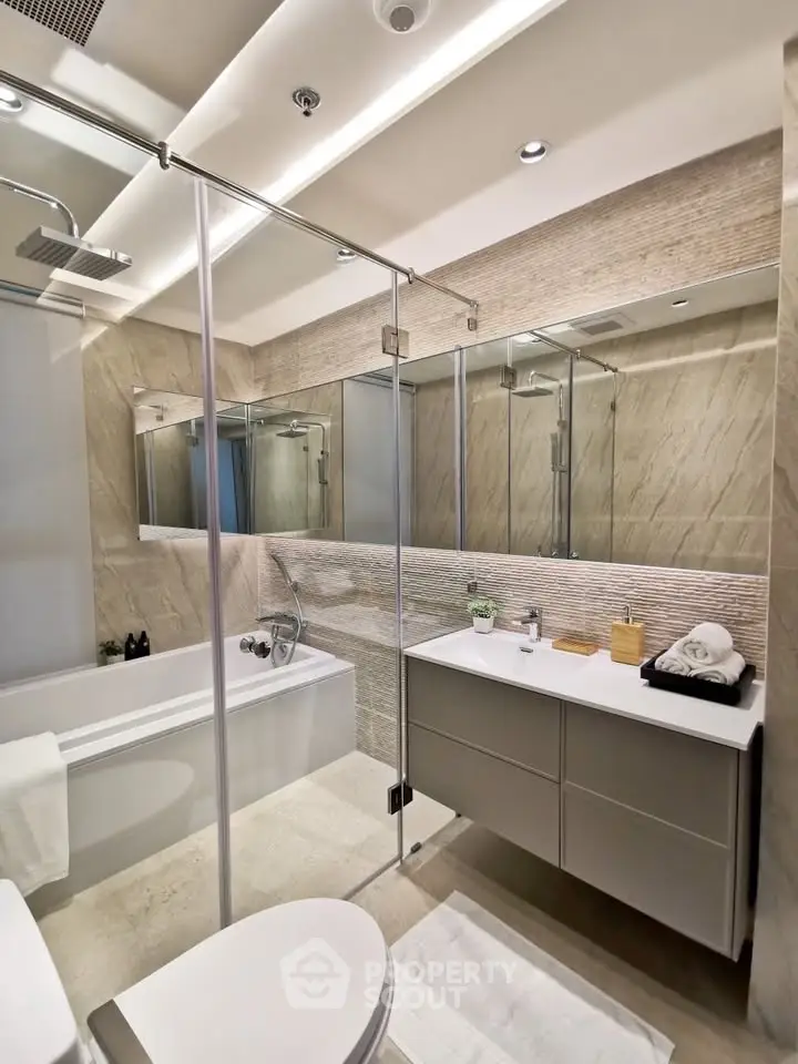Luxurious modern bathroom with glass shower and elegant fixtures