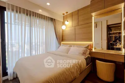 Luxurious bedroom with modern decor and large window offering stunning views.