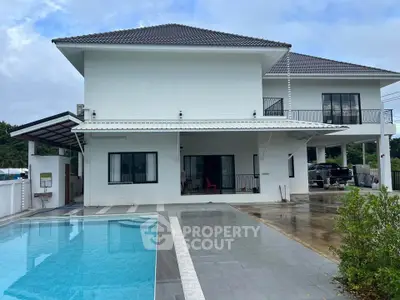 Stunning modern two-story house with pool and spacious driveway, perfect for luxury living.