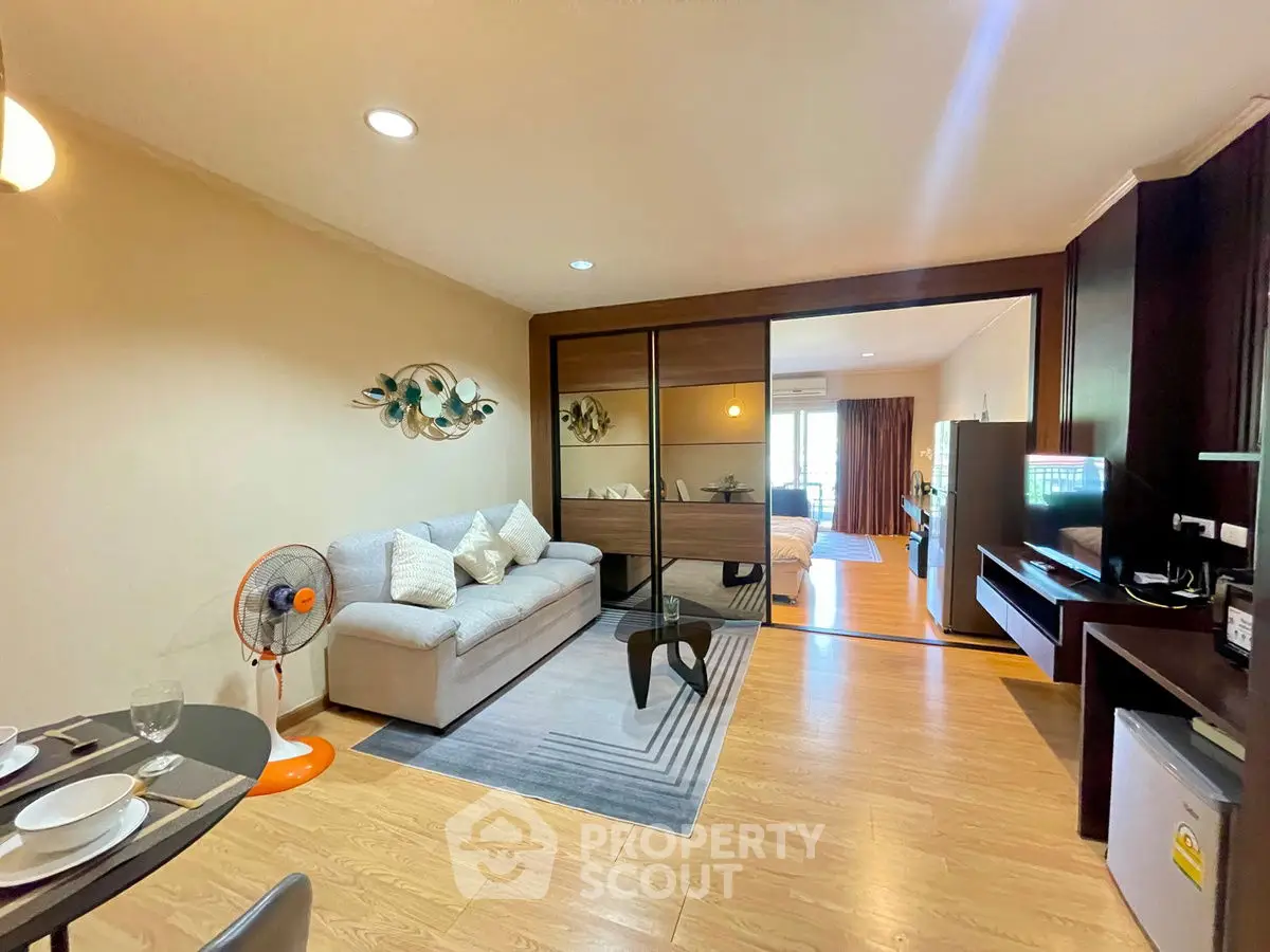Spacious living room with modern decor and open layout, featuring a cozy sofa and stylish furnishings.