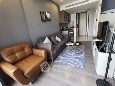 Modern living room with stylish furniture and open kitchen layout in a contemporary apartment.