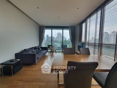 Spacious living room with modern furniture and city view, perfect for urban living.
