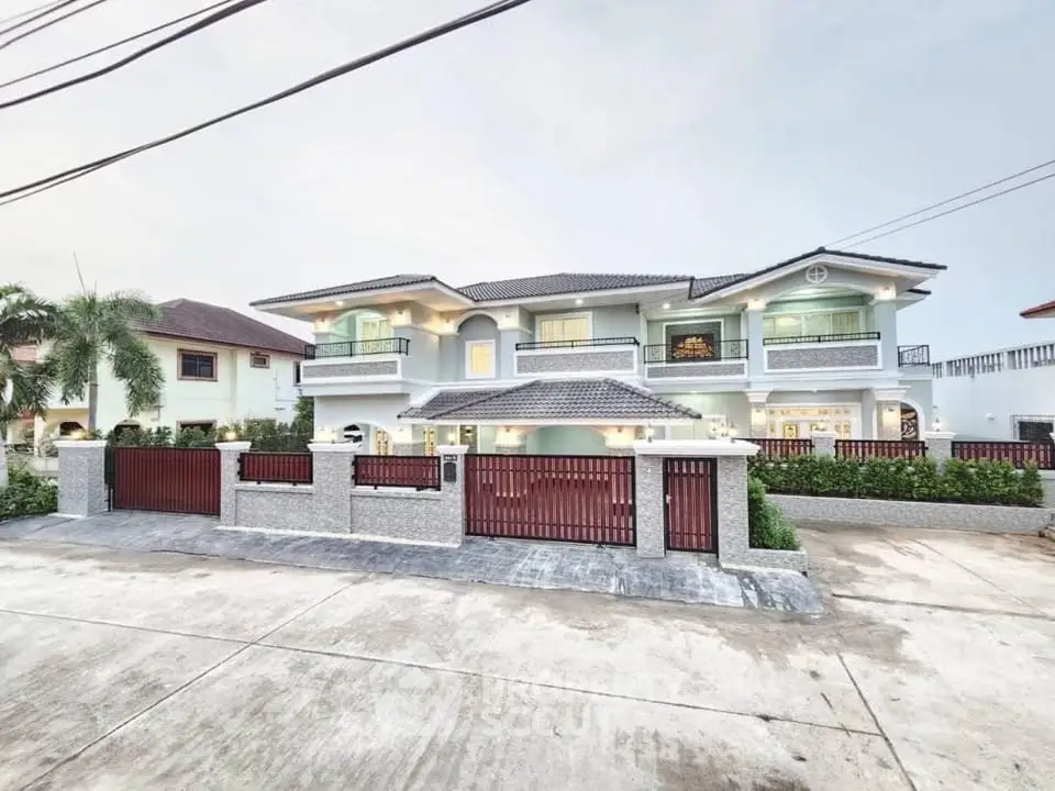 Luxurious two-story house with elegant facade and spacious driveway in a serene neighborhood.