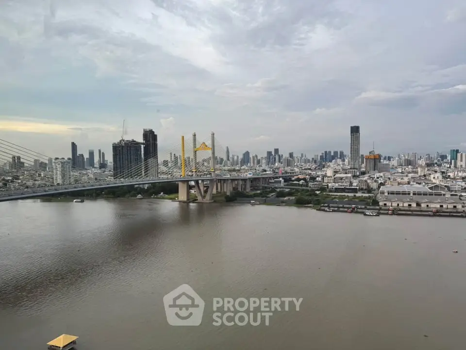 Stunning cityscape view with river and bridge, perfect for urban living enthusiasts.