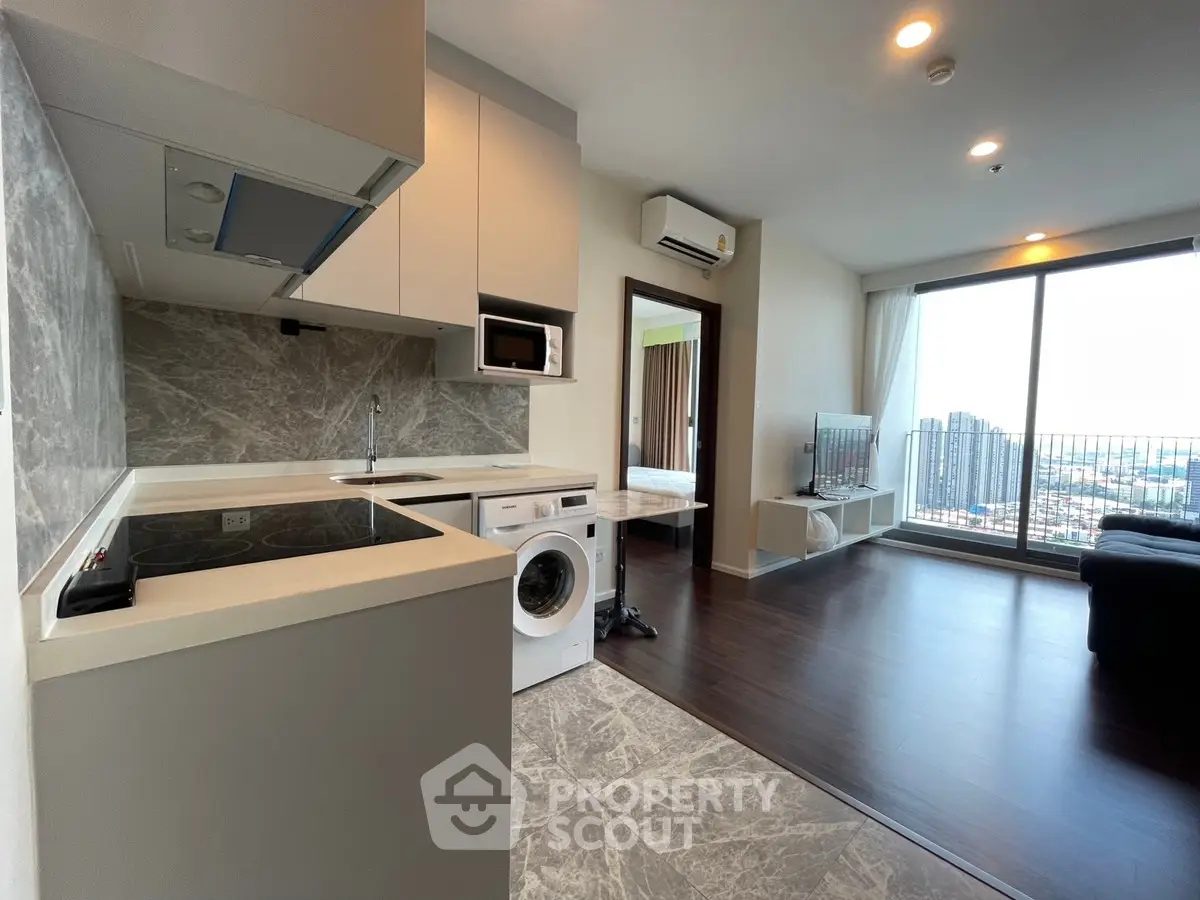 Modern open-layout kitchen and living room with city view