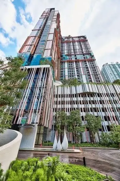 Stunning modern high-rise building with lush greenery and unique architectural design.